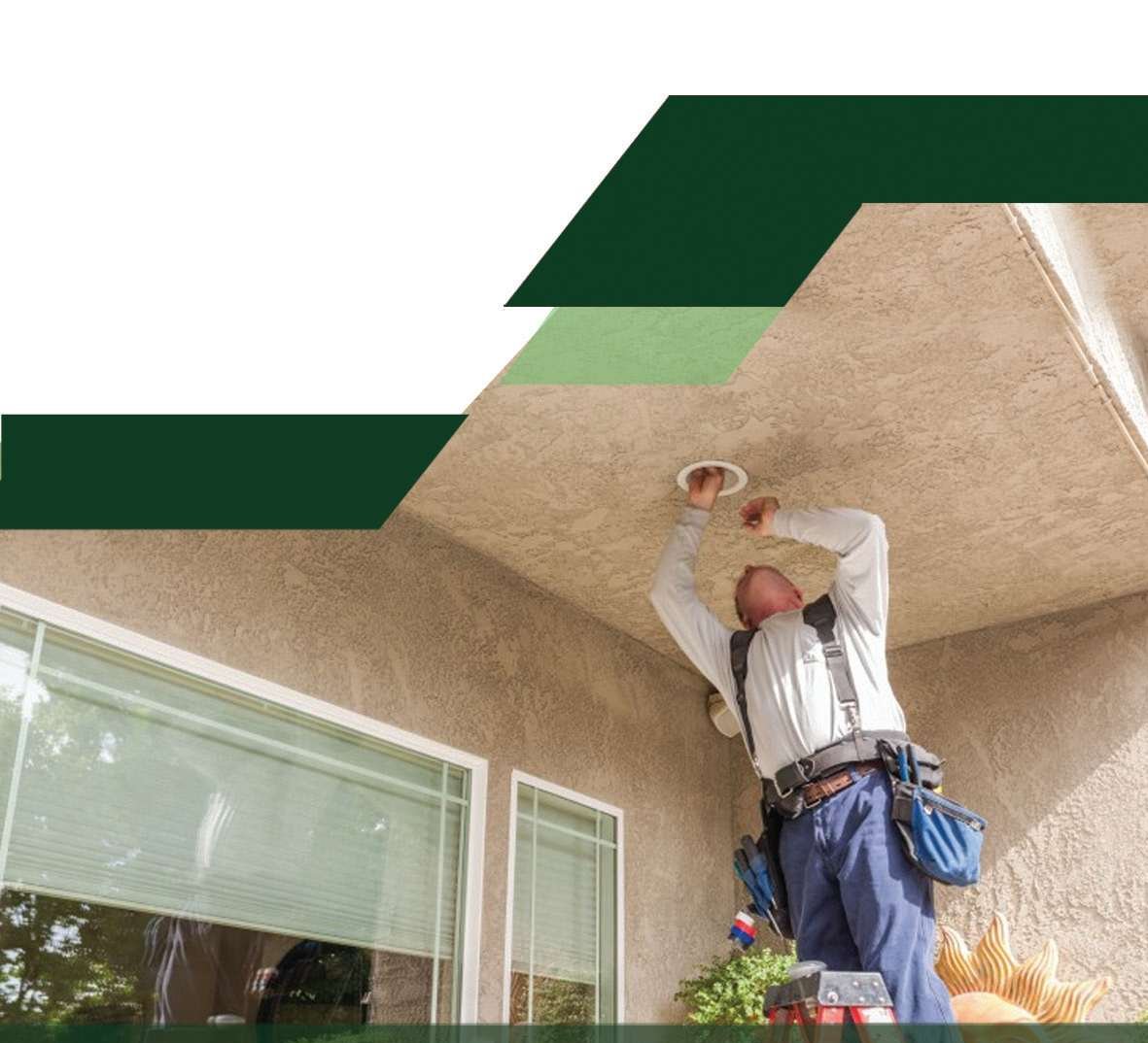 Electrician installing a ceiling light fixture